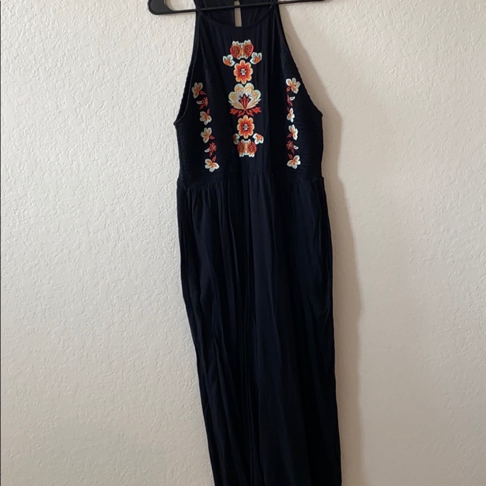 Black romper with floral embellishments